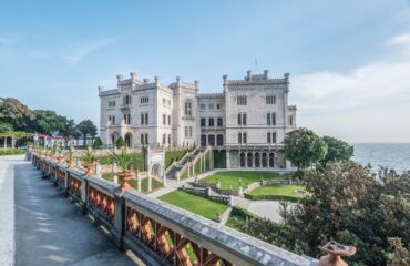 View of Miramare Castle with ocean behind.