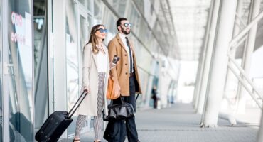 Business couple leaving the airport